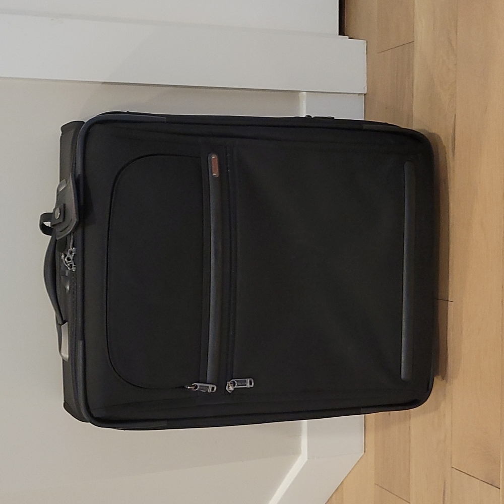 Tumi black rolling bag